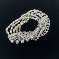 "🌼 Multi strand Silver tone stretch bracelet with chain, beads and rhinestones by Chicos. 🌼 Measures: 1 1/4\" wide.  The beads are stretchy so will fit most wrists. 🌼 Condition: very good, minimal wear. Please see all photos for complete details. For more vintage jewelry in my shop, please visit: https://www.etsy.com/shop/TheVintageDaisyVault?ref=seller-platform-mcnav&section_id=25440304" Silver Crystal Chain Bracelet For Party, Adjustable Metal Ball Chain Bracelet, Silver Metal Chain Bracelet With Rhinestones, Party Bling Metal Bracelets, Adjustable Charm Bracelet With Rhinestones For Party, Adjustable Rhinestone Charm Bracelet For Party, Elegant Beaded Metal Charm Bracelet, Silver Rhinestone Bracelet In Costume Jewelry Style, Silver Rhinestone Bracelet For Costume Jewelry