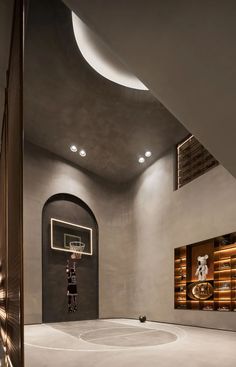 an indoor basketball court is shown in this modern home