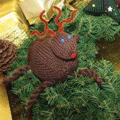 there is a crocheted christmas ornament on top of some pine branches