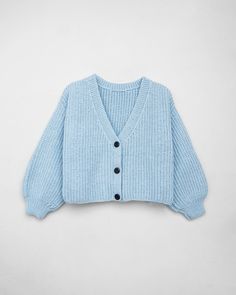 a blue cardigan sweater with buttons on the front and back, sitting against a white background