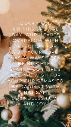 a woman holding a baby next to a christmas tree with the words dear mom on it