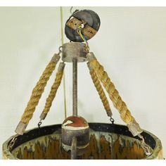 an old fashioned clock with ropes hanging from it's sides