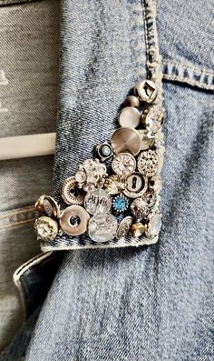 the back pocket of a jean jacket with buttons and chains attached to it's pockets