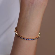 Make a shimmering statement with our Blue Diamond Tennis Bracelet. Elegant and dainty, it adds the perfect bold, finishing touch to your outfit for special occasions like anniversaries or weddings. A minimalist accessory sure to shine and a dazzling symbol of “something blue” for brides. Finish/Material: 18K Gold Over Brass ∙ Rhodium Over Brass Clasp: Box clasp and side prong closure Featuring a ~3mm Tennis Bracelet with half CZ Sapphire and half CZ Diamond stones Model showcases a romantic, min Initial Tag Necklace, Fingerprint Necklace, Sideways Initial Necklace, Dainty Initial Necklace, Bracelet Elegant, Bracelet Tennis, Diamond Huggies, Minimalist Accessories, Art Deco Diamond Rings