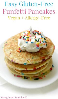 pancakes with whipped cream and sprinkles are stacked on top of each other