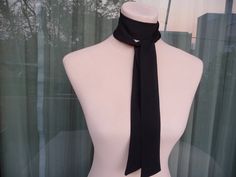 This skinny black scarf is made by 100% silk satin, and creates a beautiful and lovely picture for you to wear with your favorite outfit.  It has the perfect length to wear in different ways like as a bow, a skinny scarf or tie around your neck or on your head. It can be use as a headband and choker necklace also. So many ways to wear it!   Size: 3,5cm x 1,38 cm (28 euro) 5 cm x 138 cm (35 euro) 3,5 cm x 1,80 cm (35 euro) 5 cm x 1,80 cm (42 euro) 7 cm x 1,80 cm (49 euro) Wash gently in cold water. It's a wonderful gift choice for everyone. Check also my other silk scarves: https://www.etsy.com/shop/ArtTetisCollections Ready to ship. Thank you for visiting my shop. Formal Scarf Neckwear, Elegant Adjustable Neckwear For Gifts, Elegant Adjustable Neckwear As Gift, Elegant Adjustable Neckwear As A Gift, Chic Black Silk Scarf Gift, Classic Satin Scarves As Gift, Elegant Silk Scarf With Ribbon For Gift, Elegant Silk Scarf With Ribbon, Silk Party Ties