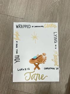 a sticker with the words wrapped in wrapping on top of a wooden floor next to a christmas tree