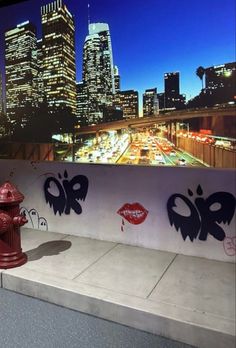 a red fire hydrant sitting on the side of a wall