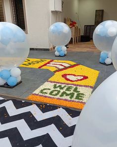 some balloons are on the ground in front of a sign that says cake and ice cream