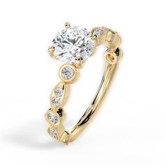 a yellow gold engagement ring with diamonds