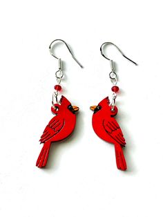 These red cardinal earrings are the perfect holiday earrings and a thoughtful way to commemorate a loved one. It is a common belief that cardinals are sent by loved ones who have passed on to convey hope and joy to the bereaved. These colorful holiday earrings are made of wood that I have handpainted and lacquered. They hang on sterling silver ear wires. They also feature a tiny red faceted glass bead. The drop is one and a half inches and the cardinals themselves are just over one inch tall. Th Personalized Red Drop Earrings, Personalized Red Dangle Earrings, Multicolor Bird Design Earrings As A Gift, Cardinal Bracelet, Whimsical Bird Design Earrings For Gift, Cardinal Earrings, Silver Bird-shaped Earrings For Gift, Bird Earrings, Holiday Earring