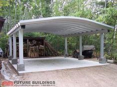 a covered parking lot in the middle of a wooded area