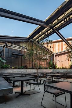 tables and chairs are set up under an awning