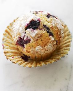 a blueberry muffin sitting on top of a white counter