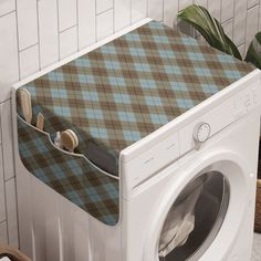 a washer and dryer sitting next to each other in front of a tiled wall