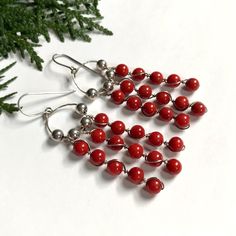 Long dangling beaded earrings made of sterling silver and red coral.  The wire has some subtle bends (see photos), but they are otherwise in great vintage condition.  The ear hooks are marked '925', and I've also tested them with nitric acid to confirm they are completely sterling silver. Length: 2.85 inches (73 mm) Weight: 11.7 grams Message if you have any questions  : )   Vintage jewelry: good for humanity and the earth. By buying preowned jewelry, you have avoided supporting the harmful mini Gift Sterling Silver Wire Wrapped Beaded Earrings, Red Sterling Silver Wire Wrapped Earrings, Gift Earrings With Silver Plated Wire, Silver Plated Wire Earrings With Round Beads For Gift, Red Nickel-free Chandelier Earrings As Gift, Red Beaded Sterling Silver Earrings, Sterling Silver Earrings With Dangling Beads For Gifts, Sterling Silver Beaded Earrings As Gift, Sterling Silver Earrings With Silver Beads