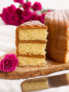 a piece of cake sitting on top of a wooden cutting board