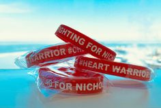 Nicholas CHD Fundraiser Silicone Wristband/ Bracelet in Red | Ink Injected | Debossed Message on wristband: Fighting for Nicholas #Heart Warrior #CHD This is to raise awareness for Nicholas and his ongoing battle with Congenital Heart Disease. All Sales go towards his medical expenses.  Each wristband is individually wrapped in clear packaging and will be shipped in a yellow 8x6 padded shipping envelope.  Ink Injected and Debossed: Fundraiser Message for Nicholas is etched into the band and then Red Band Bracelet For Gift, Red Band Bracelet As Gift, Adjustable Red Wristband, Heart Warrior, Clear Packaging, Heart Defect, Congenital Heart, Shipping Envelopes, Wristband Bracelet