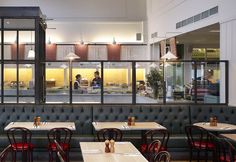 an empty restaurant with tables and red chairs