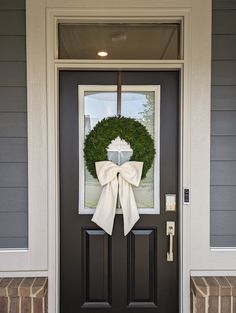 the front door is decorated with a wreath and a cross on it's side