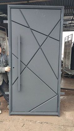 a man is standing in front of a door that has an interesting design on it