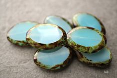 several blue and brown glass buttons on a table