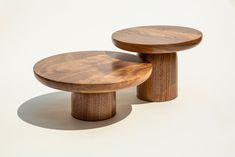 two wooden stools sitting next to each other