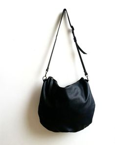 large black leather bag .This bag is so comfortableand and versatile you can use it as a shoulder bag ,and cross body bag *   long adjustable strap attached*  Closed with metal zipper*  One zipper pocket inside*  2 open pocket inside*  Flat figure*  Italian leather* cotton liningApprox. dimensions: 14" x 16" incSee for more bags and purses here:http://www.etsy.com/shop/Smadars?ref=pr_shop_more**** A small surprise waiting for anyone who buys more than one item ***** Small Hand Bags, Brown Leather Backpack, Black Leather Bag, Bags And Purses, Black Leather Tote, Leather Bag Women, Cute Purses, Black Leather Bags, Brown Bags