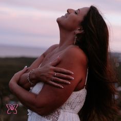 a woman with her arms crossed looking up at the sky