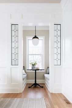 an empty room with white walls and wood floors