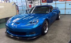 a blue sports car parked in a garage