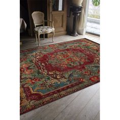 a large rug with an ornate design in red and green