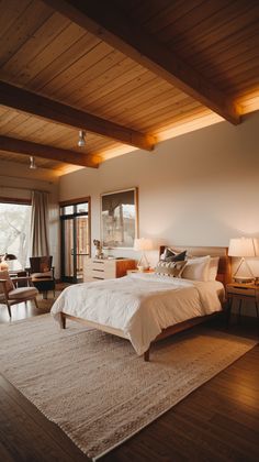 a large bed sitting in the middle of a bedroom on top of a wooden floor