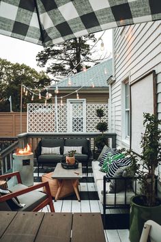 an outdoor living area with patio furniture and lights