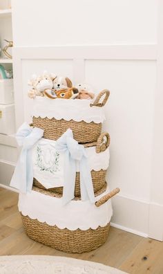 three baskets stacked on top of each other with stuffed animals in the bottom one basket