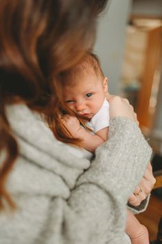 a woman holding a baby in her arms