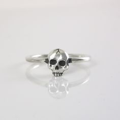 Mini Skull Ring ~ Hand made to order ~ Sized to order - if you need an additional size please specify the size in a note during checkout ~ Sterling Silver ~ Stamped with Artist Signature and .925 ~ Please allow 5-10 business days to make ring before shipping  ~Thank You! Adjustable Skull Rings With Symbolic Style, Adjustable Sterling Silver Skull Ring, Unique Skull Rings For Gifts, Unique Nickel-free Skull Ring Gift, Unique Nickel-free Skull Ring, Handmade Symbolic Skull Ring As Gift, Handmade Symbolic Skull Ring For Gift, Symbolic Handmade Skull Ring Gift, Handmade Adjustable Skull Ring Gift