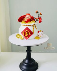 there is a cake that looks like it has been decorated with gold and red decorations