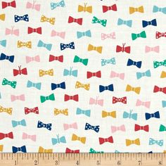 a white background with multicolored bow ties on it and a ruler in the foreground