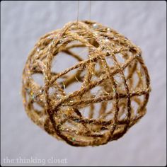 an ornament made out of rope and string hanging from a threaded ball