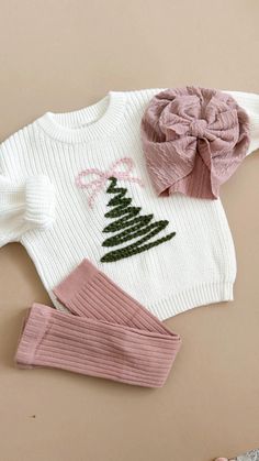 Wrap your little one in festive coziness with our hand-stitched Christmas tree sweater! Made from warm knit fabric, this adorable white sweater features a charming green tree design, topped with a delicate coquette pink bow for a touch of holiday sweetness. Perfect for keeping baby stylishly snug all season long. Ideal for family gatherings, baby announcements, newborn photoshoots, or simply spreading cheer wherever they go!  This listing is for Christmas Tree sweater only. If you want a different color, just send us a convo Hand embroidery on a chunky sweater True to size Custom orders welcome Christmas Sweater Diy, Coquette Sweater, Embroidered Christmas Tree, Merry Christmas Baby, Christmas Tree Sweater, Tree Sweater