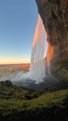 a large waterfall spewing out water into the air