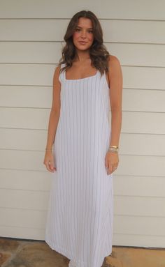 The perfect, casual dress for summer! The Never Better Dress is a lightweight linen blend maxi dress in a shift silhouette. It features a soft square neckline and wide straps - all in a white fabric with pinstripes. Rosalind is 5'8" and is wearing size small size small measurements: 34" bust | 53" length 60% polyester | 40% linen PRODUCTS ON SALE ARE FINAL SALE! Feel free to email us at orders@shopriffraff.com or DM us with any questions regarding fit, styling, or our return policy in general. Casual Maxi Dress With Straight Neckline, Summer Maxi Dress With Straight Neckline For Daywear, Summer Linen Maxi Dress With Square Neck, White Maxi Dress With Straight Neckline For Day Out, White Maxi Dress With Vertical Stripes For Spring, Casual Square Neck Maxi Dress For Daywear, Casual Maxi Dress With Square Neck For Daywear, Summer Maxi Dress With Straight Neckline, Spring Maxi Dress With Straight Neckline For Daywear