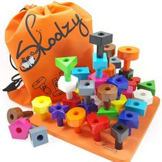 an orange bag filled with colorful wooden toys