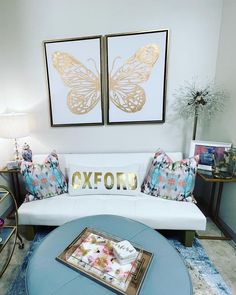 a living room filled with furniture and pictures on the wall above it's coffee table