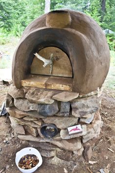 an outdoor oven made out of rocks and wood