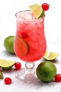 the cherry limeade vodka cocktail is garnished with cherries and limes