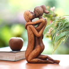 a wooden figurine holding a baby in its arms