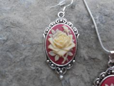 "For sale are beautiful flawless (perfect cream colored rose with a single bud, on a maroon/red background) cameo pendant necklace and matching earrings set The cameos are gorgeous, very detailed They are offered at a reasonable price, make perfect gifts, and are wonderful quality The cameo is set in an ornate tibetan silver setting, and the chain is 22\" .925 silver plated 1.2mm snake chain, with a lobster claw clasp The earrings match perfectly, and the earring hooks are .925 silver plated and Classic Rose-colored Formal Jewelry, Rose Classic Formal Jewelry, Classic Rose Design Jewelry For Gifts, Rose Oval Jewelry With Rose Design, Oval Rose Jewelry With Rose Design, Rose Vintage Sterling Silver Jewelry, Maroon Red Background, Cameo Pendant Necklace, Gray Bracelet