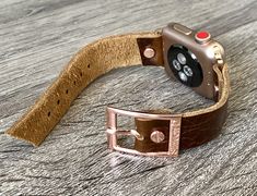 High Quality Italian Brown Grain Leather Bracelet. Designed And Handmade by Simeon D Jewelry Studio. Adjustable Size Bracelet Perfectly Tailored for Your Wrist. This Bracelet Fits ALL Apple Watch Series. Not For Other Models. Apple Watch Is NOT Included. Please Measure Your Wrist Before Submitting Your Order! Follow my Studio on Social Media for Updates & New Designs. Create Your Own Unique Style! Be Different! Be Unique! Make a Fashion Statement Every Place You Go! Get Tons of Compliments W Gold Leather Strap Apple Watch Band For Everyday, Everyday Gold Leather Strap Apple Watch Band, Everyday Gold Apple Watch Band With Leather Strap, Brown Rectangular Apple Watch Band Gift, Gold Rectangular Leather Strap Apple Watch Band, Gold Rectangular Leather Apple Watch Band, Gold Rectangular Apple Watch Band With Leather Strap, Rectangular Apple Watch Band Gift With Wrist Strap, Everyday Rectangular Bracelet Watch Band